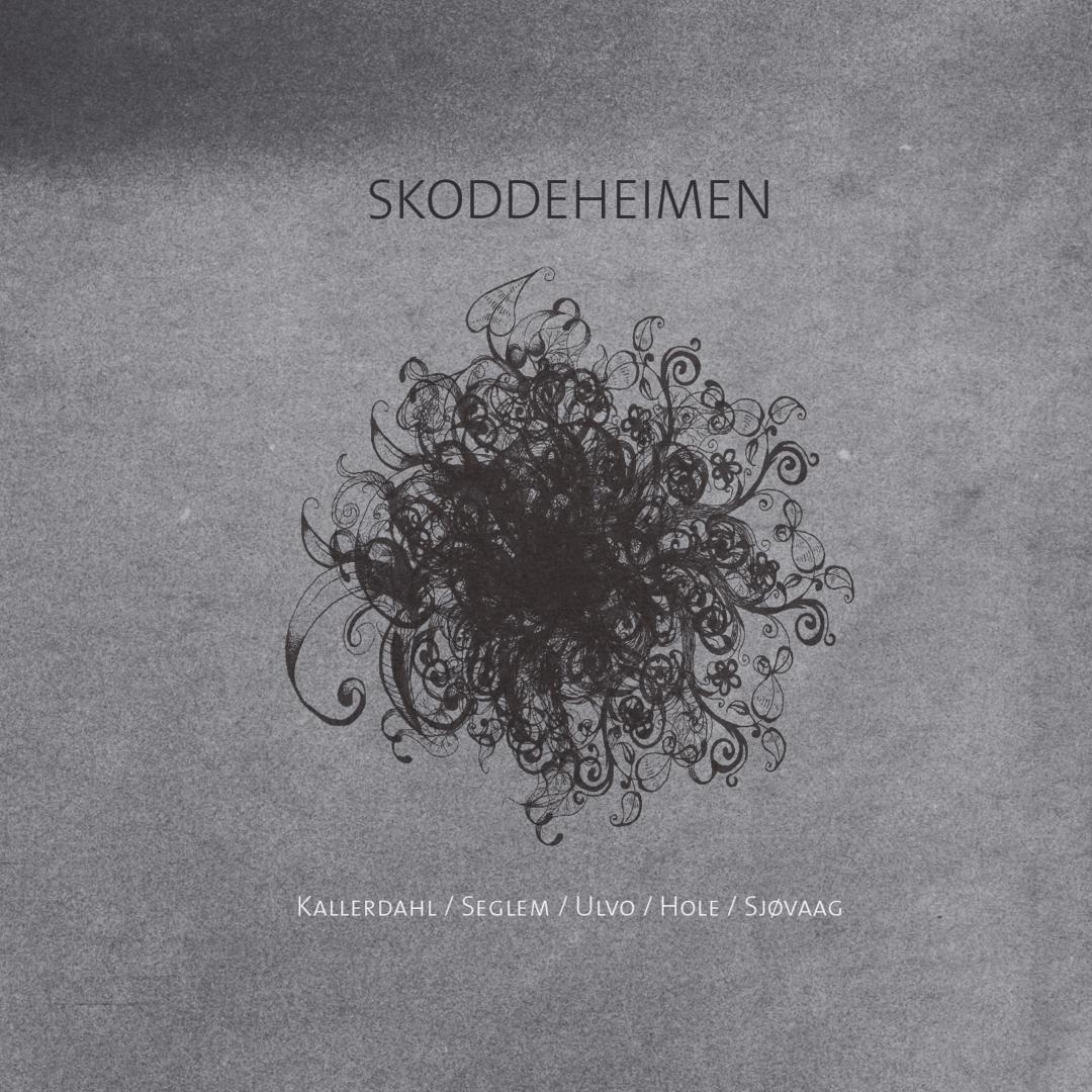 Gray textured album cover with ornate black floral mandala design centered below "SKODDEHEIMEN" title and artist names at bottom