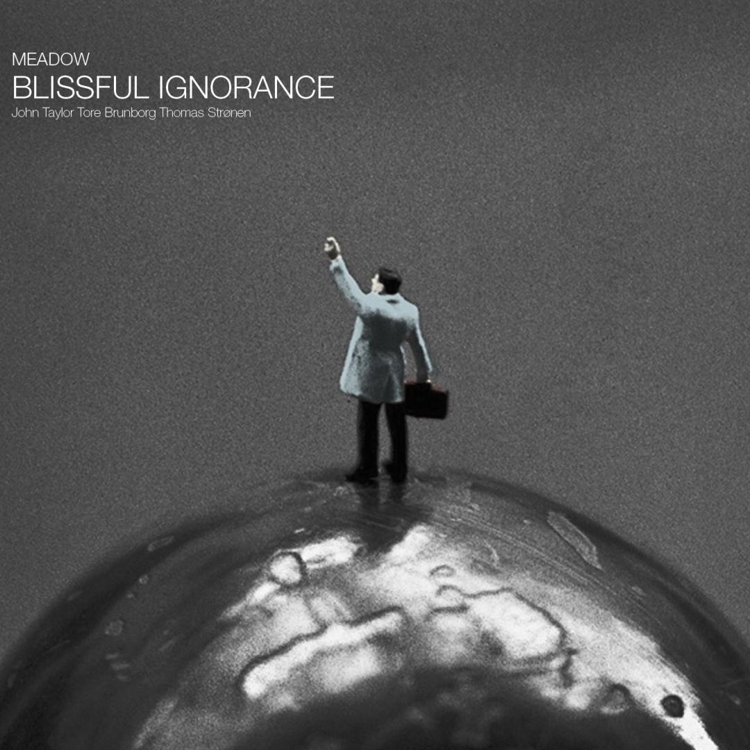 Black and white album cover showing a small suited figure with briefcase standing on a globe against gray background, arm raised upward.