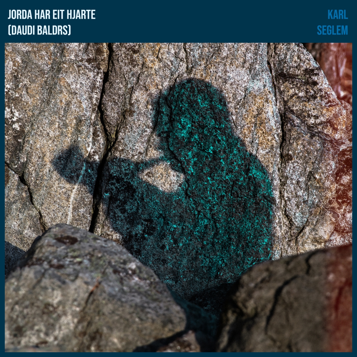 Weathered rock formation with striking turquoise-green mineral deposits creating an abstract human-like silhouette against gray stone surface