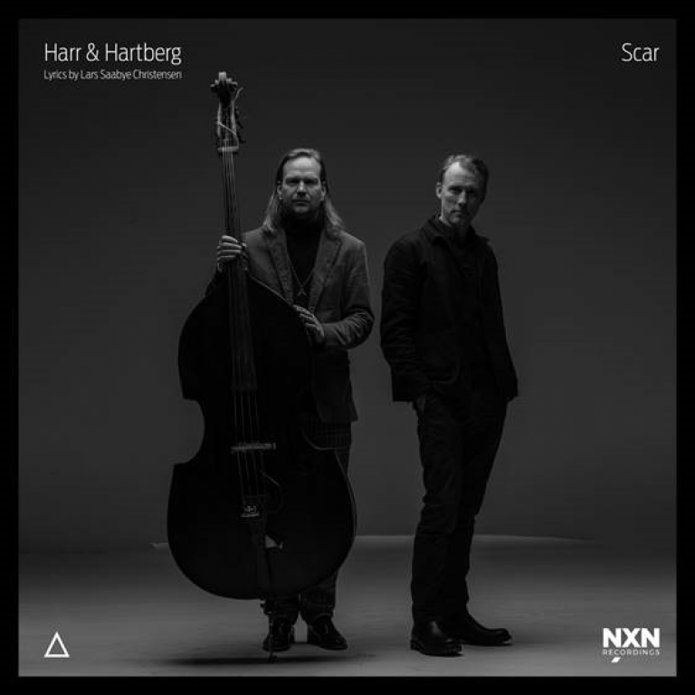Black and white album cover showing two men in dark clothing against gray background, one holding upright bass, minimalist composition with "Scar" title