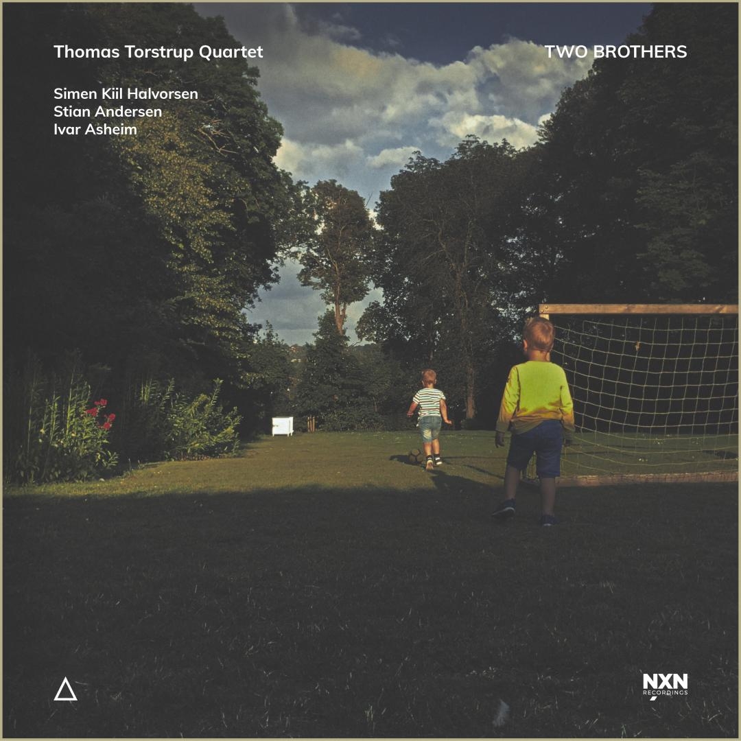 Album cover showing two boys in a garden - one in striped shirt walking away, another in yellow shirt by soccer goal under cloudy sky with lush trees