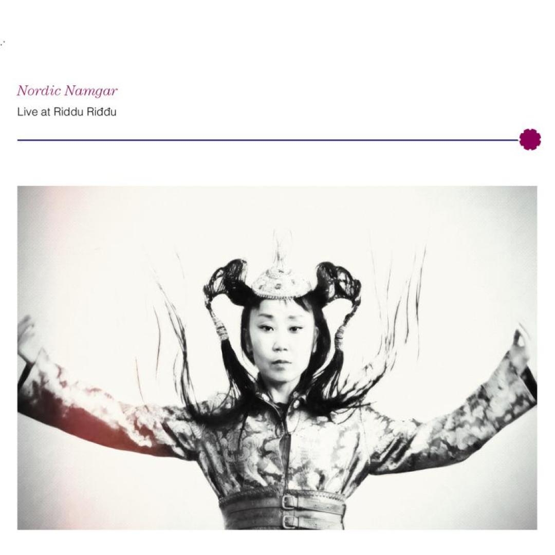 Black and white album cover showing a person with ornate traditional dress and headdress, arms raised dramatically against a light background.