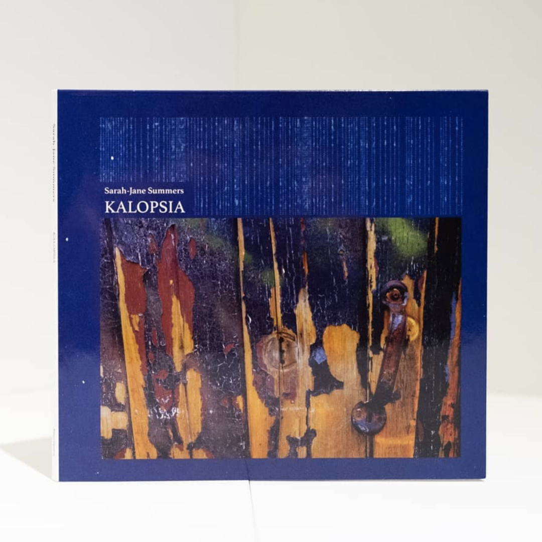 Dark blue album cover featuring abstract artwork with weathered wood textures in browns and yellows, titled "KALOPSIA" by Sarah-Jane Summers in white text.