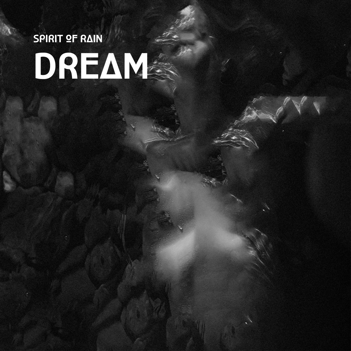 Black and white underwater scene showing blurred figures swimming, creating dreamy, ethereal atmosphere with flowing water distortion effects