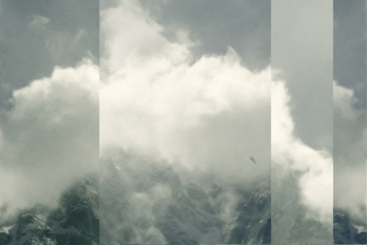 Dramatic white clouds enveloping dark mountain peaks in moody grayscale tones, creating an atmospheric forest hiking view with layered composition.