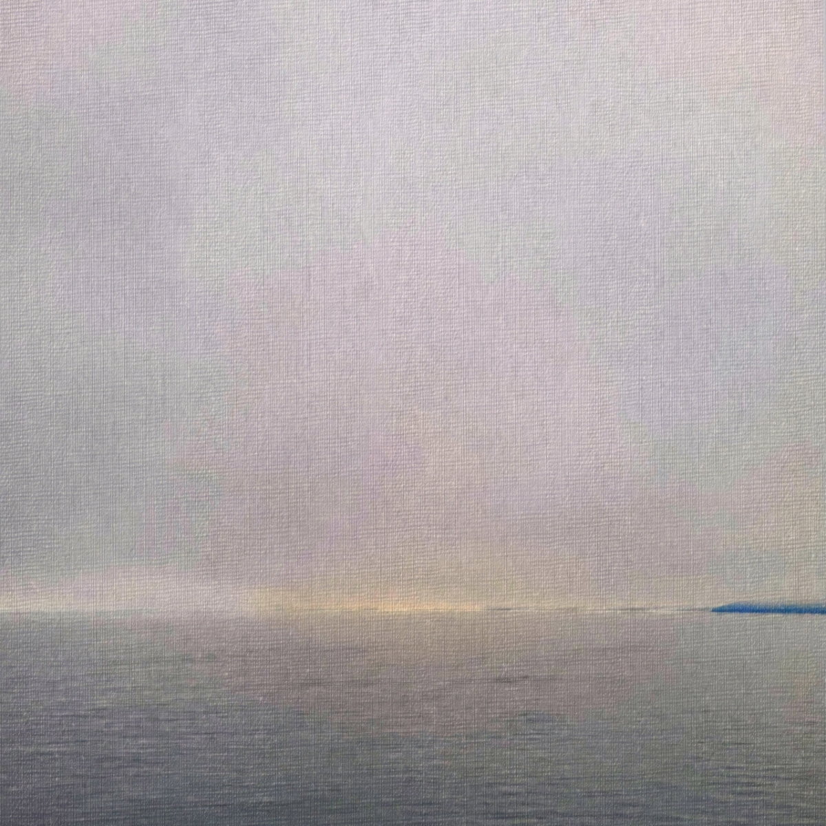 Misty seascape with pale purple and silver sky reflecting over calm waters, distant horizon with subtle warm light and blue accent on right