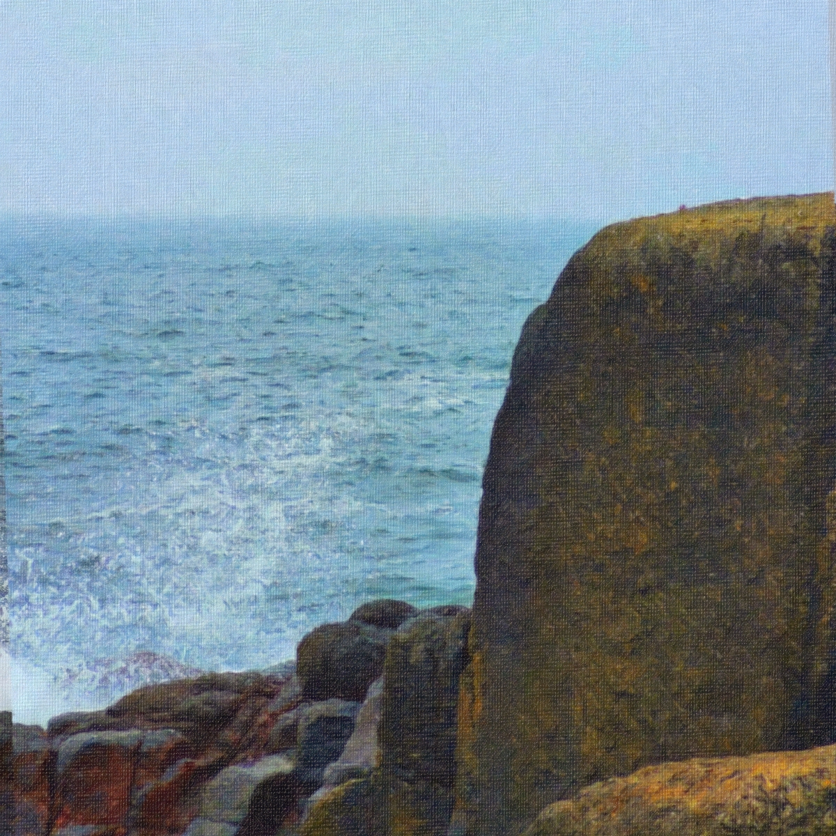 Misty coastal scene with weathered brown cliffs overlooking turquoise ocean waters under pale blue sky, creating moody seascape atmosphere