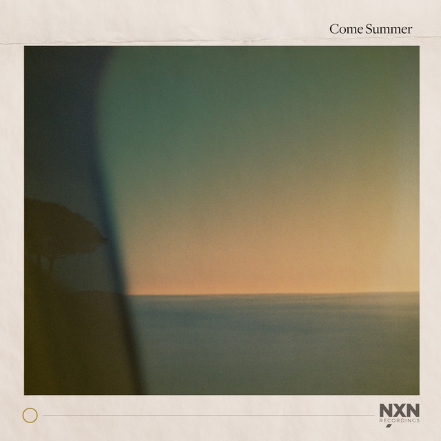 Soft dreamy seascape with warm orange-green gradient sky blending into calm blue waters, featuring a shadowy vertical element on the left side