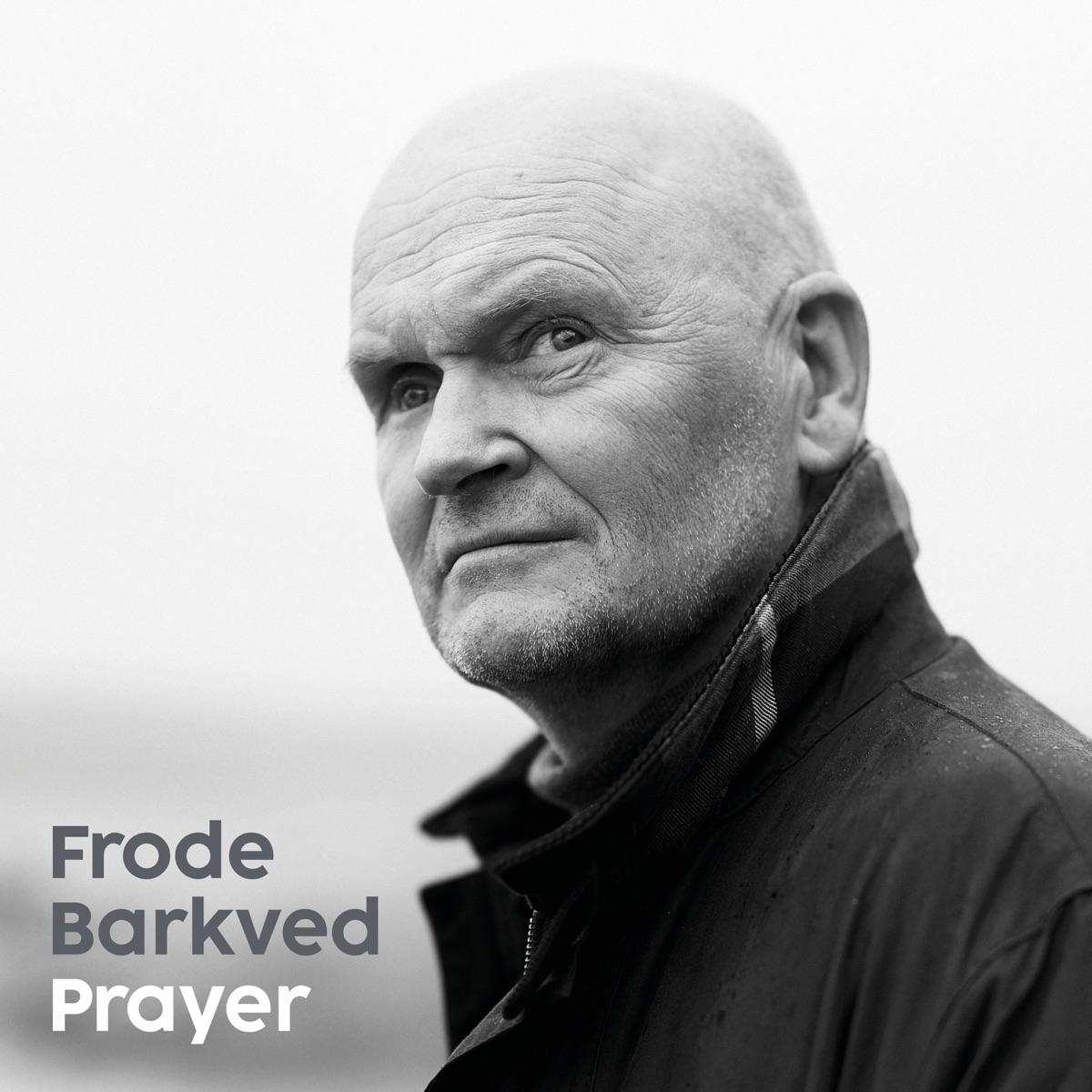 Black and white portrait of bald man in dark jacket looking contemplatively upward, with "Frode Barkved Prayer" text overlay on left side.