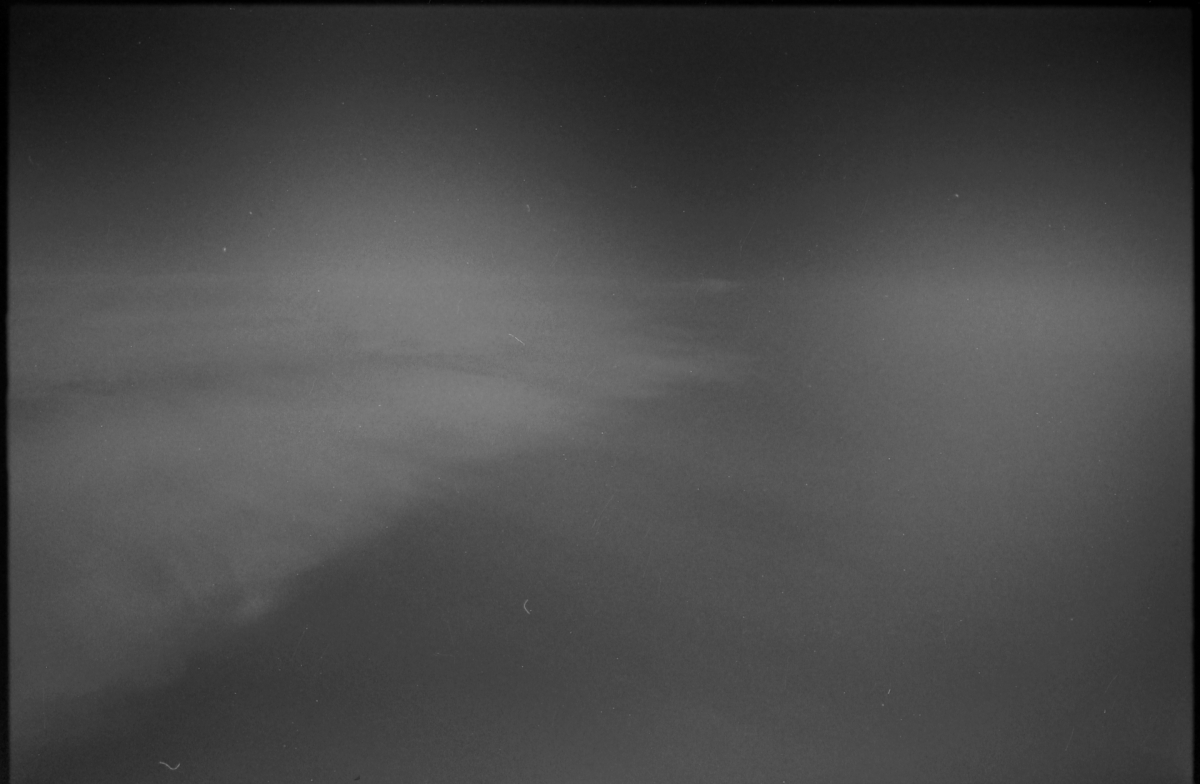 Dark moody black and white sky with wispy clouds and subtle light gradients creating an atmospheric, ethereal composition