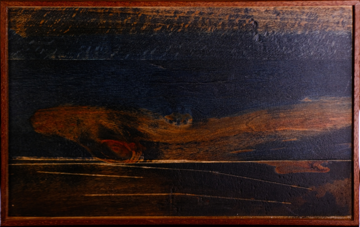 Dark wooden box with swirling grain patterns in browns and blacks, displaying natural wood texture and craftsmanship against black background.