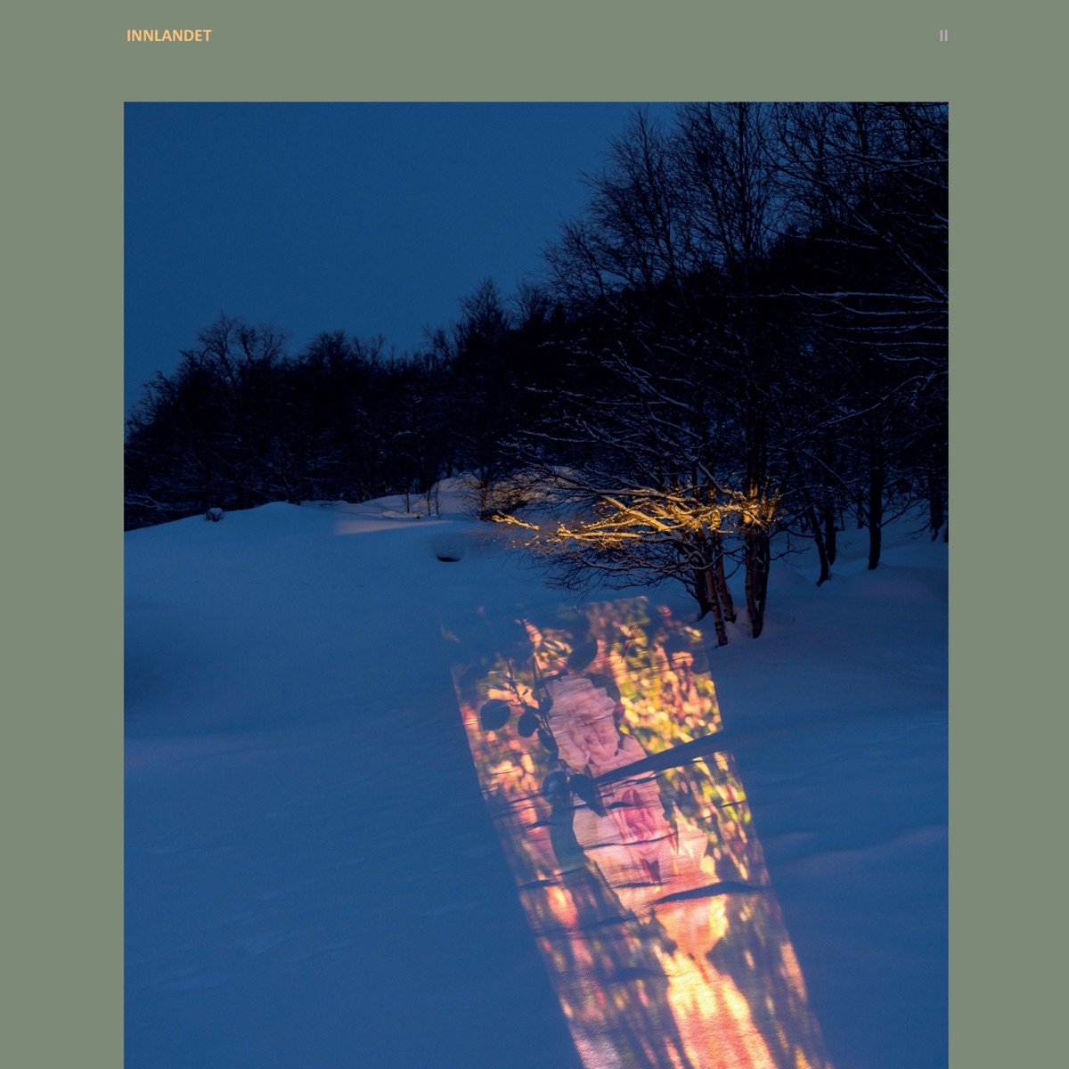 Snow-covered winter landscape at twilight with illuminated stained glass window panels creating warm colorful reflections on blue snow, bare trees silhouetted against deep blue sky