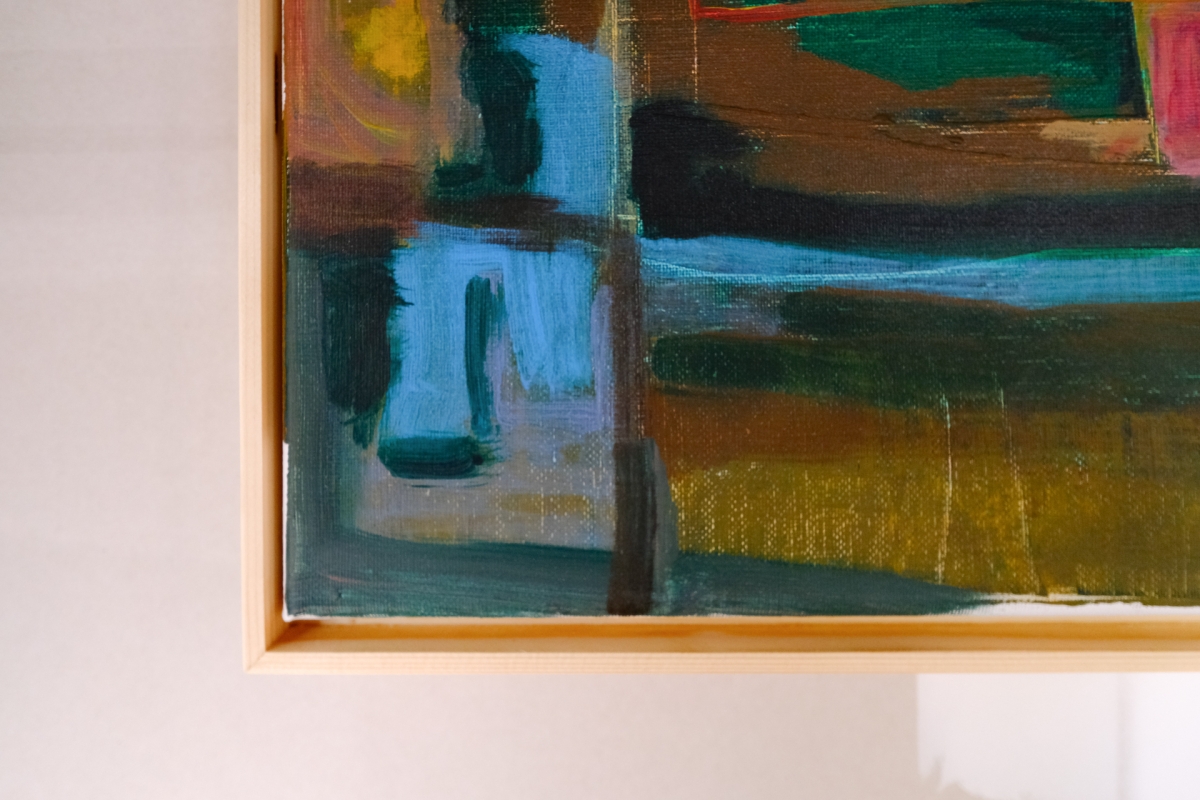 Corner detail of an abstract painting in a natural wood frame, with bold brushstrokes of teal, olive green, brown, and black.