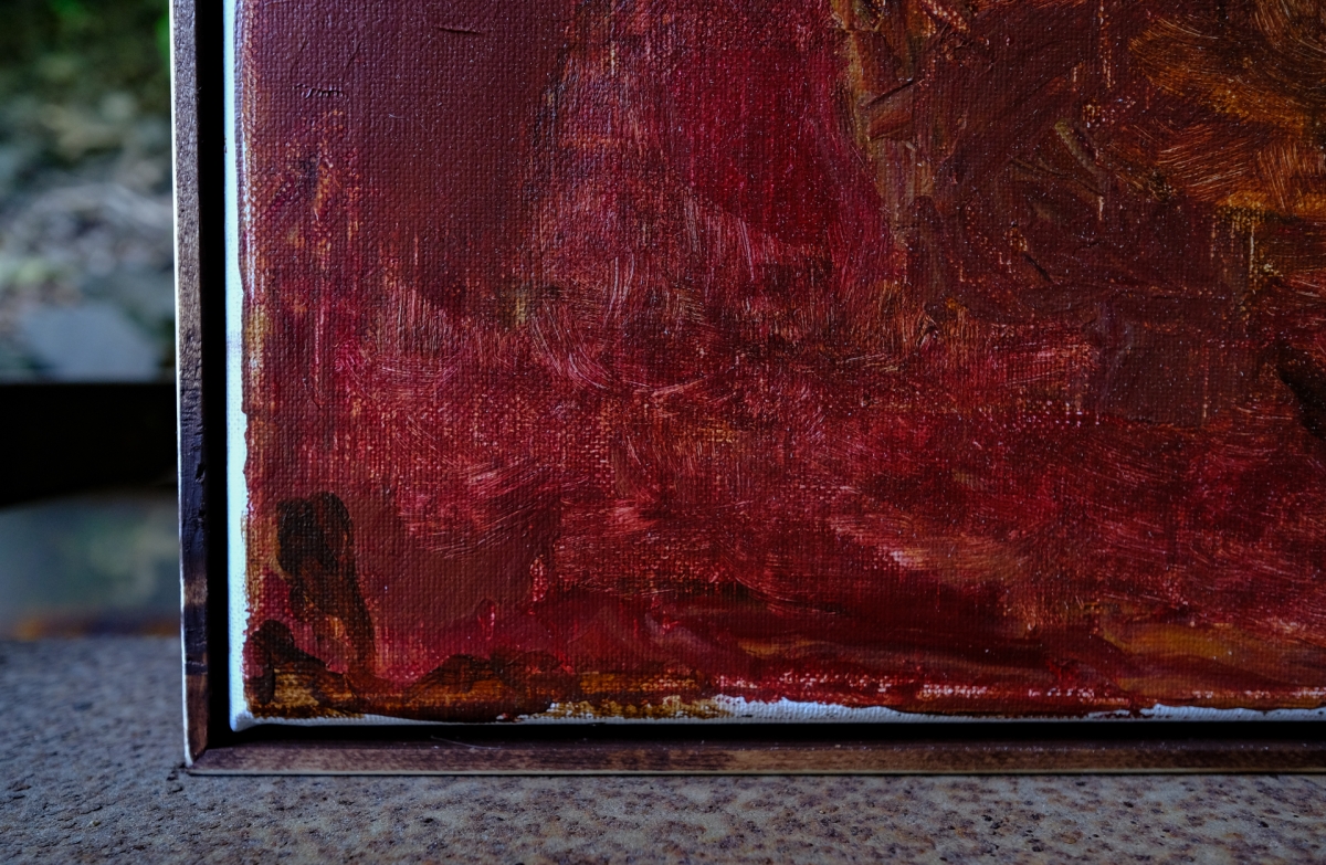 Close-up of oil painting corner showing deep red and burgundy brushstrokes with textured canvas edge and visible artist signature