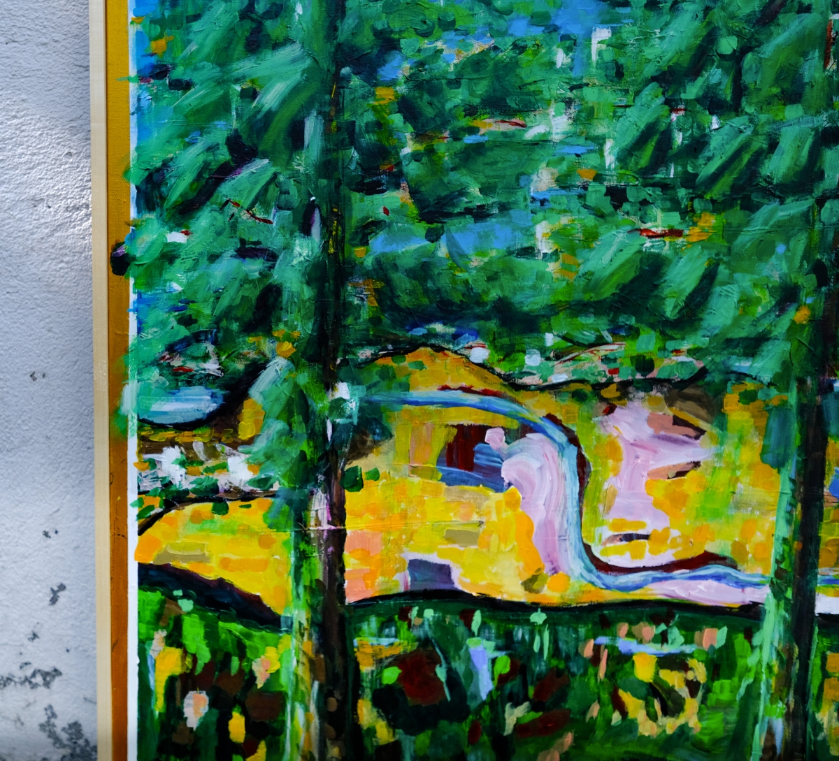 Textured painting of dense green forest with tree trunks, showing a winding blue river through golden-yellow fields, leaning against a white wall.
